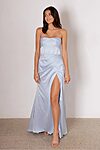 Model wearing the Layana bridesmaid dress by Tania Olsen in light satin, featuring a strapless corset bodice, draped waist, and A-line skirt with high-leg split.