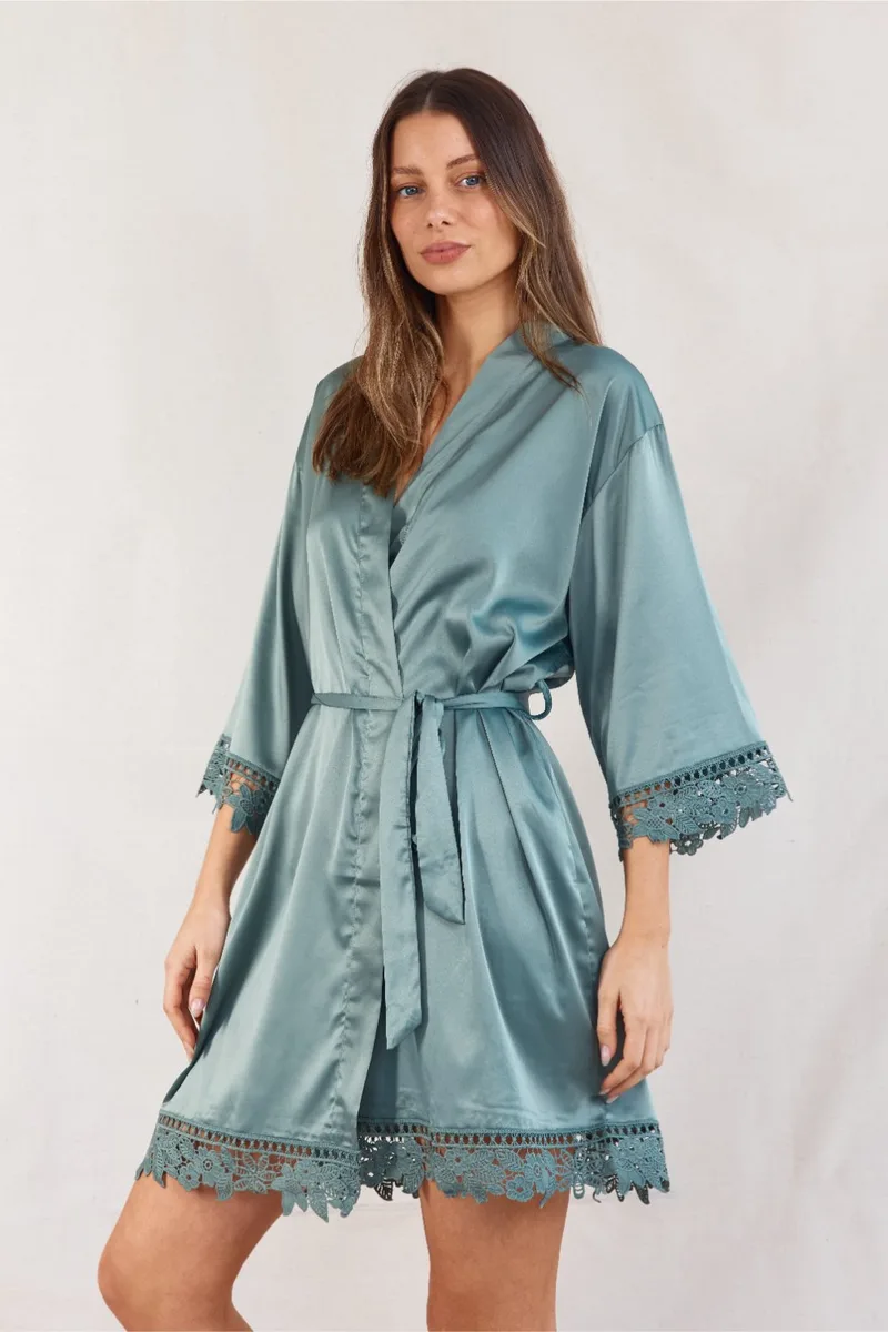 A satin bridesmaid robe in eucalyptus green with lace trim