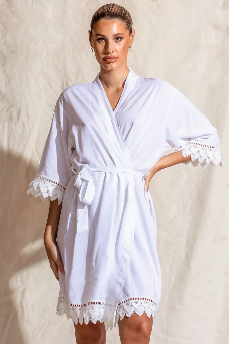 A white matte robe with feather lace trim for the bride
